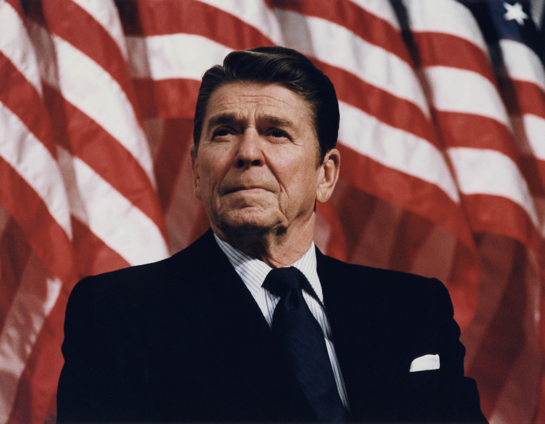 Ronald reagan in front of a flag